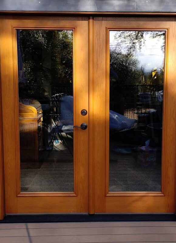 Custom wood French patio doors with energy-efficient glass, installed in a Sacramento home for enhanced style, insulation, and natural light.