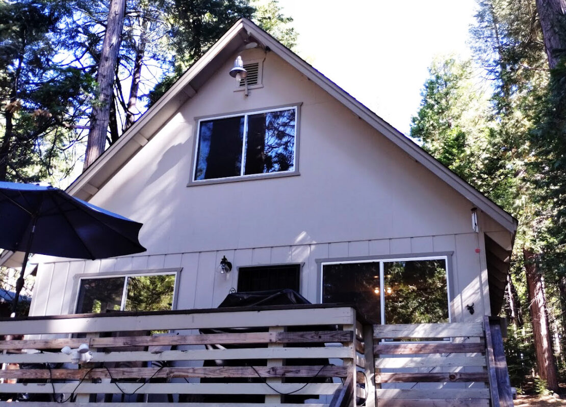 Energy-efficient vinyl sliding window installation in a rustic cabin, featuring dual-pane, low-E glass for enhanced insulation, natural light, and weather resistance.