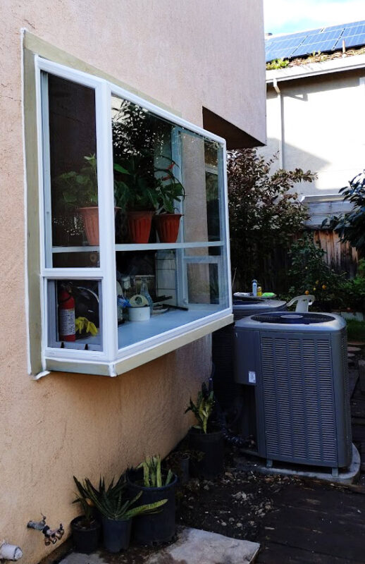 Custom garden bay window installation with energy-efficient glass and vinyl frame in Sacramento, designed for extra sunlight, airflow, and plant shelving.