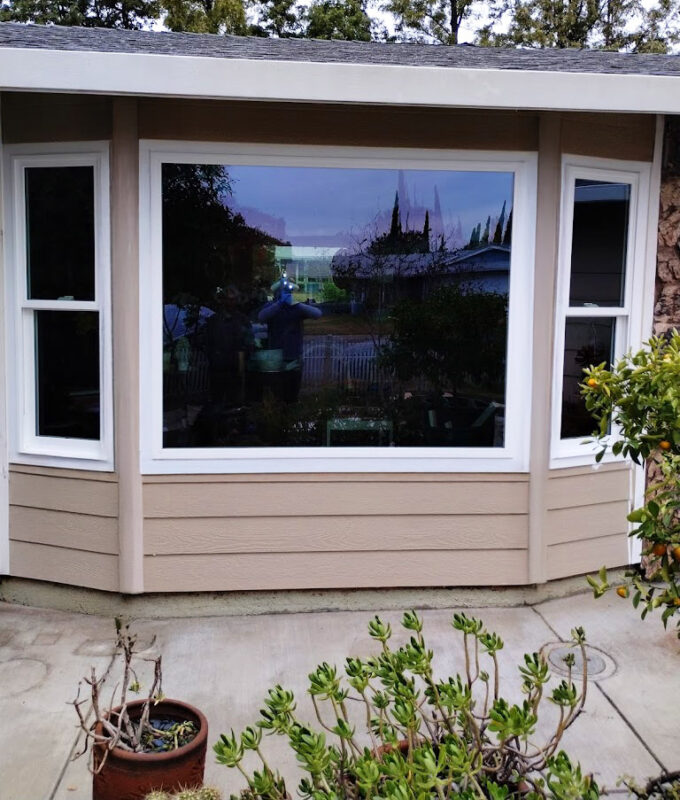 Custom bay window installation in Sacramento featuring a large center picture window with operable casement side windows, designed for energy efficiency, natural light, and enhanced curb appeal.